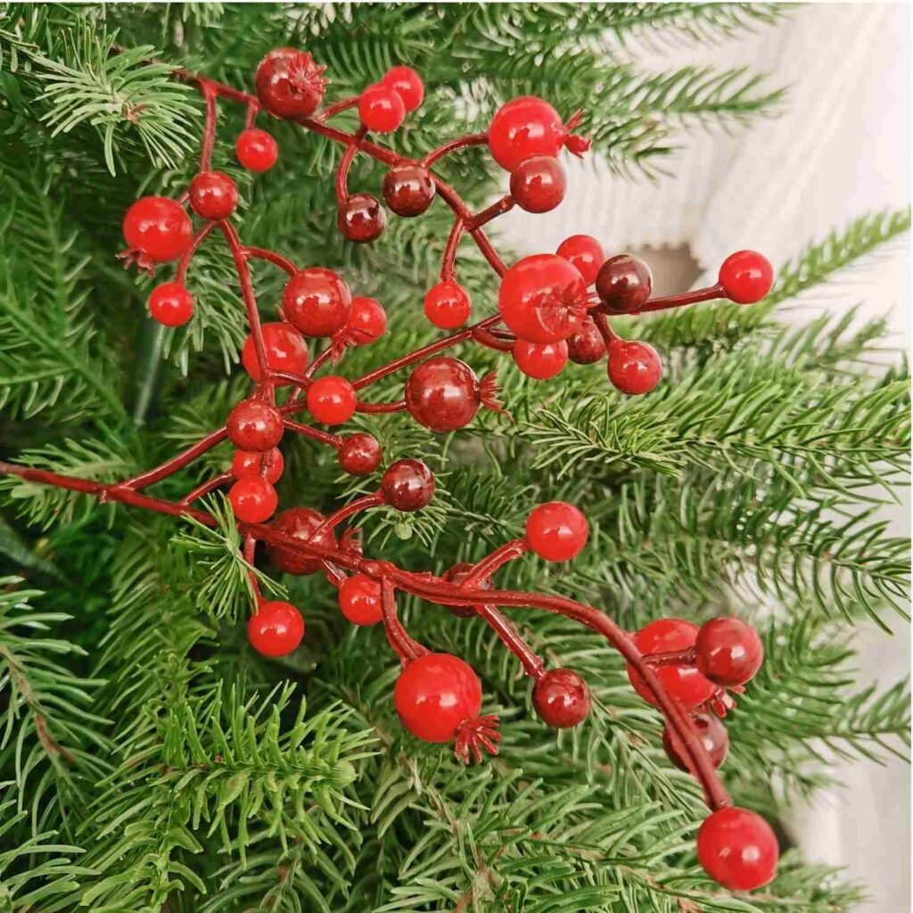 Artificial berries add a rustic feel and a pop of color, making them a versatile addition to any tree.