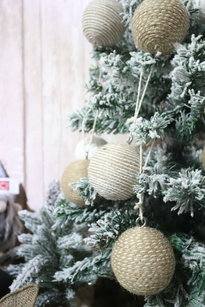 Wooden ornaments and berry clusters bring a touch of natural elegance, ideal for rustic or country-themed trees.